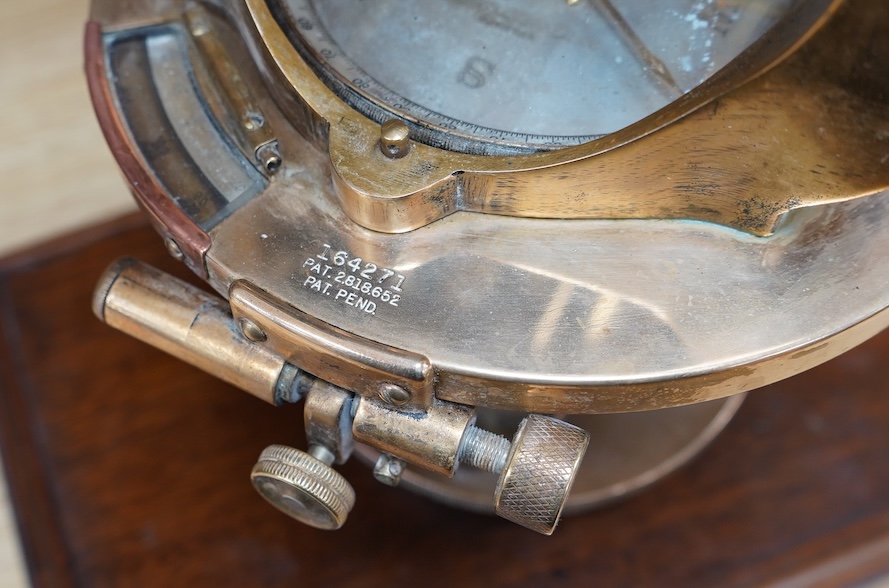 An early 20th century American brass theodolite by Keuffel and Esser Co. mounted on a mahogany base, 39.5cm high. Condition - fair to good.